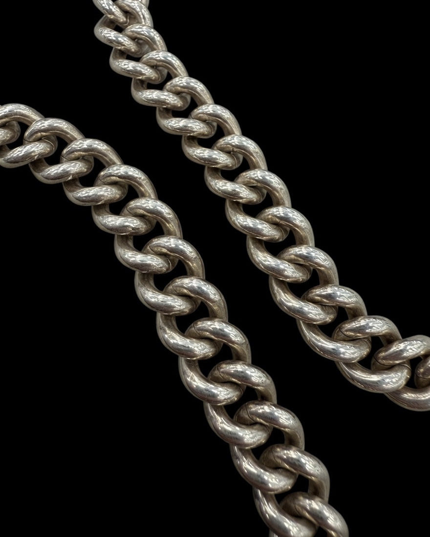 Close-up of a silver chain on a black background